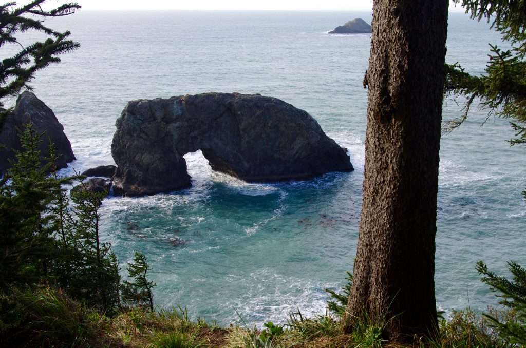 A rock arch in the ocean.