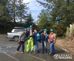 A group of volunteers strike silly poses after a trail party.