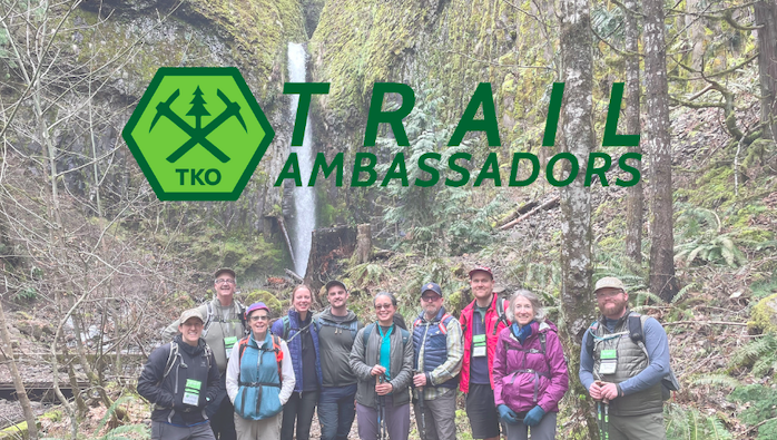 A large group of TKO Trail Ambassadors stand in front of a waterfall. The image is overlaid by the TKO logo.